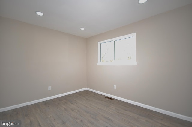 unfurnished room with wood-type flooring