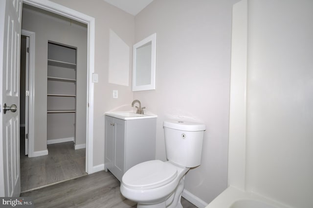 bathroom featuring hardwood / wood-style flooring, vanity, and toilet