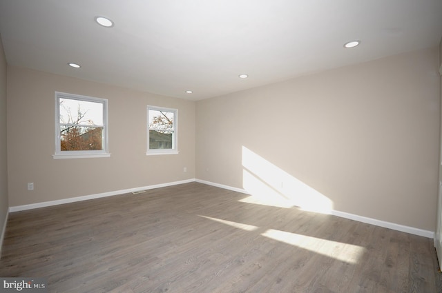 spare room with dark wood-type flooring