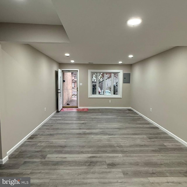 basement with hardwood / wood-style flooring and electric panel