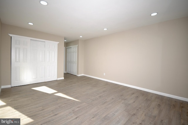 unfurnished bedroom with hardwood / wood-style floors and a closet