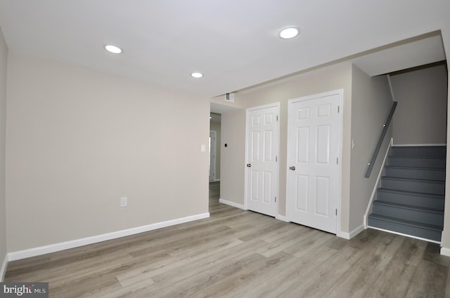 basement with light hardwood / wood-style flooring