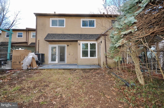 back of house featuring central AC unit and a patio area