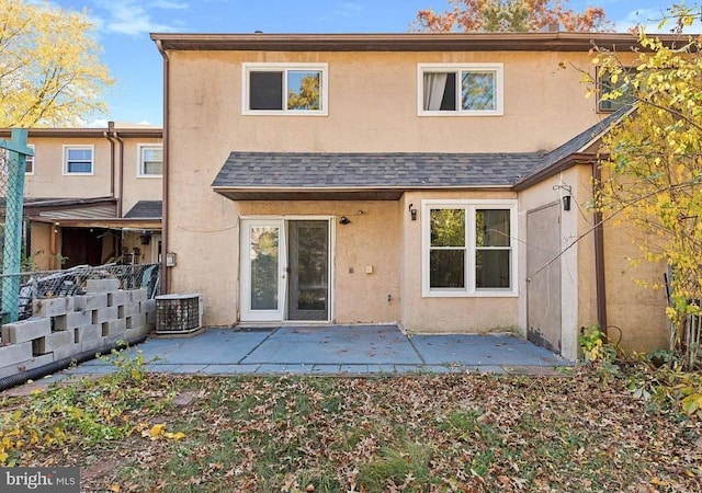 back of property with a patio area and central air condition unit