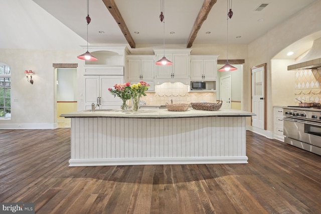 kitchen featuring dark wood-style floors, appliances with stainless steel finishes, backsplash, and beam ceiling