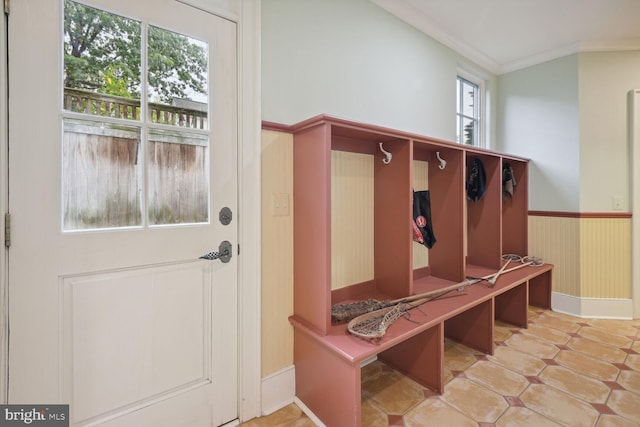 mudroom featuring wainscoting, tile patterned flooring, and crown molding