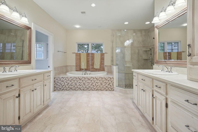 full bath featuring two vanities, a sink, and a shower stall