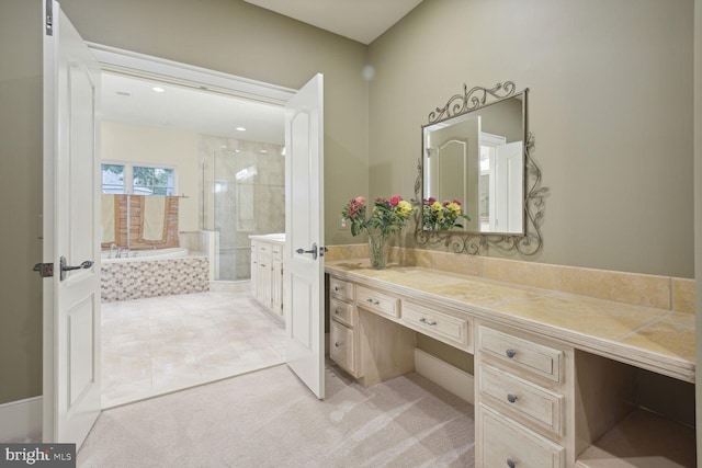 bathroom with a garden tub, a shower stall, and vanity