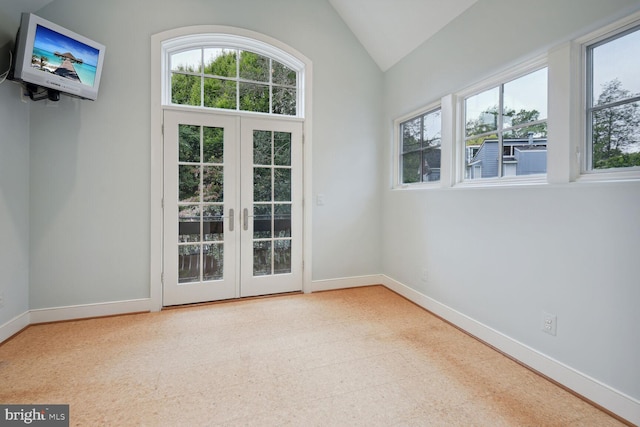 entryway featuring lofted ceiling, french doors, tile patterned floors, and baseboards