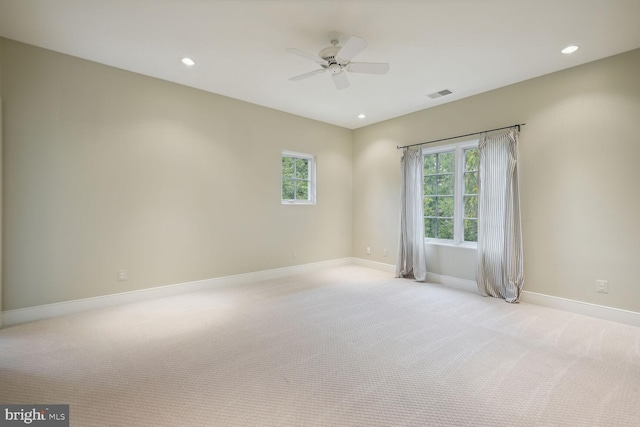 empty room featuring recessed lighting, visible vents, light carpet, and baseboards