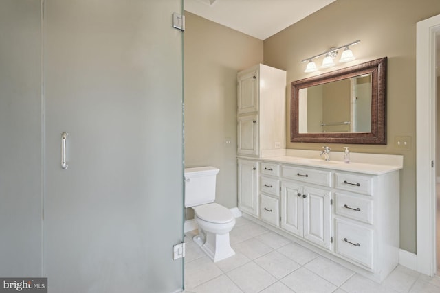 full bathroom with baseboards, vanity, toilet, and tile patterned floors