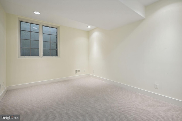 carpeted spare room with recessed lighting, visible vents, and baseboards