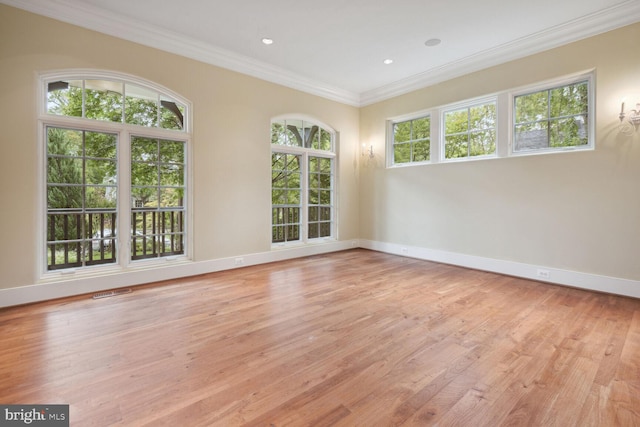 spare room featuring light wood-style flooring, ornamental molding, baseboards, and recessed lighting