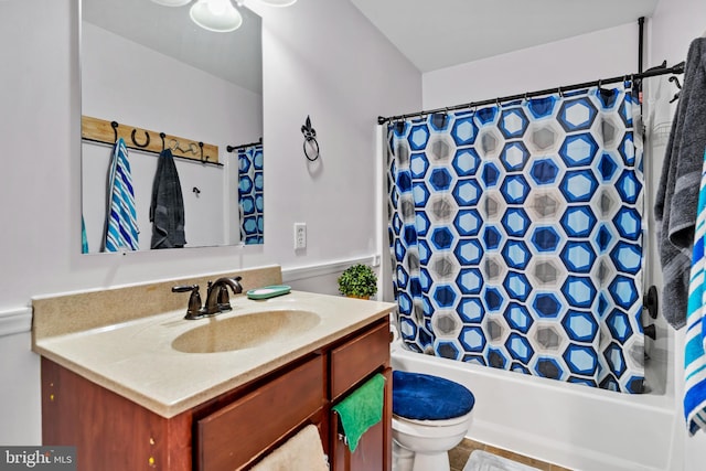 full bathroom with vanity, shower / bath combo with shower curtain, and toilet