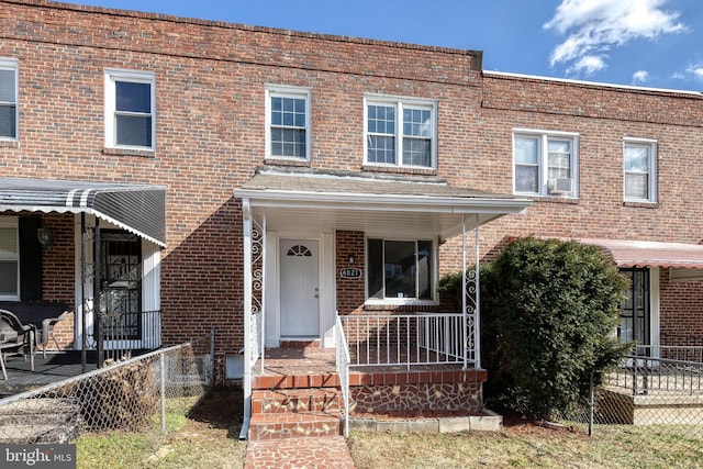 townhome / multi-family property featuring cooling unit and covered porch