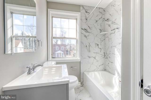 full bathroom with vanity, tiled shower / bath combo, plenty of natural light, and toilet