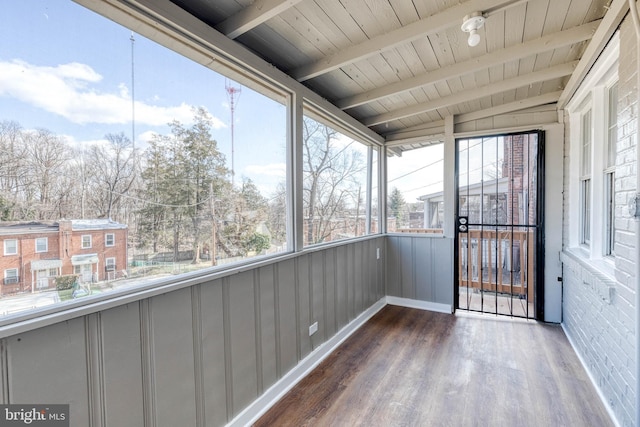 unfurnished sunroom featuring beamed ceiling and wooden ceiling