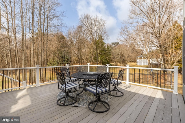 wooden terrace with outdoor dining space