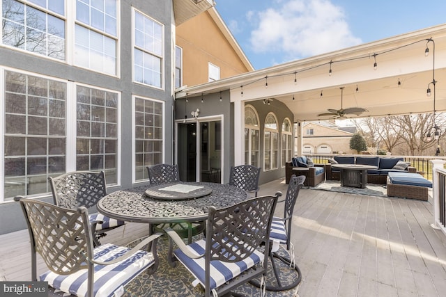 view of patio / terrace featuring outdoor dining area, ceiling fan, an outdoor living space, and a wooden deck