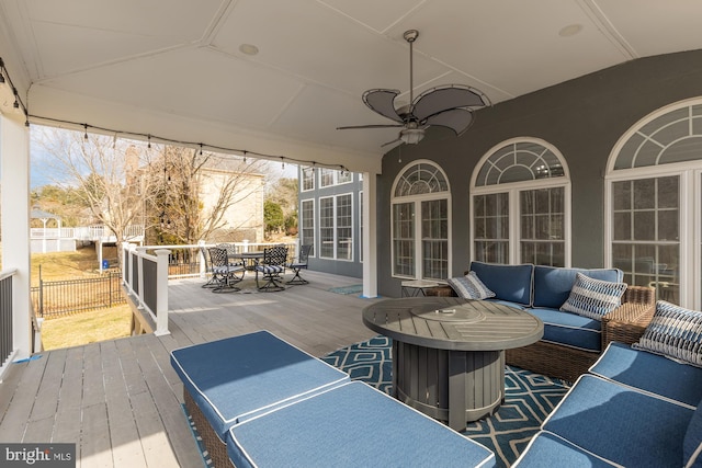 view of patio / terrace with ceiling fan, outdoor dining area, fence, an outdoor living space, and a wooden deck