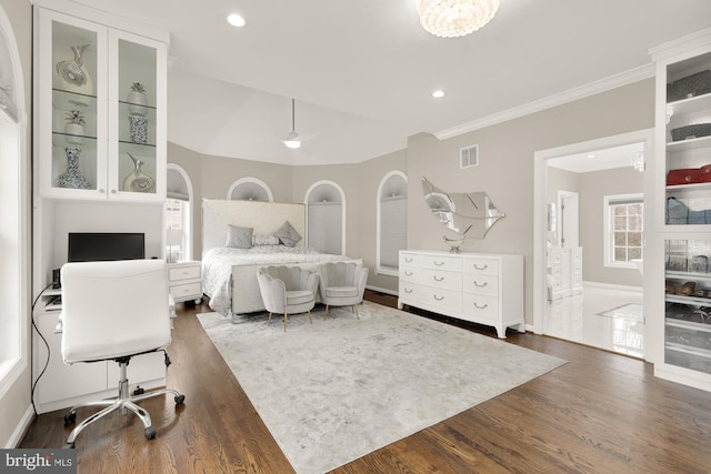 bedroom with dark wood-style flooring, crown molding, recessed lighting, visible vents, and baseboards