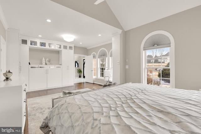 bedroom with ornamental molding, recessed lighting, lofted ceiling, and wood finished floors