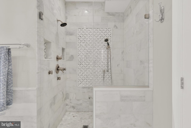 bathroom with tiled shower