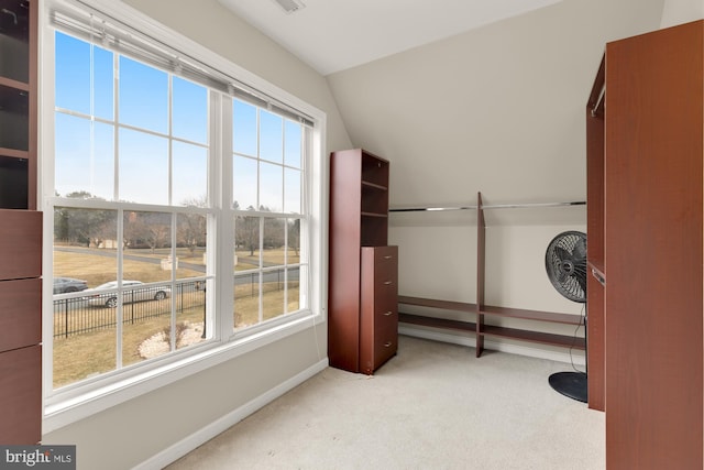 workout area featuring lofted ceiling, carpet, and baseboards