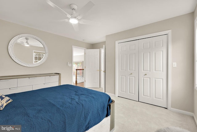 carpeted bedroom featuring a closet, a ceiling fan, and baseboards