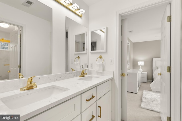 full bath featuring double vanity, a sink, visible vents, and connected bathroom