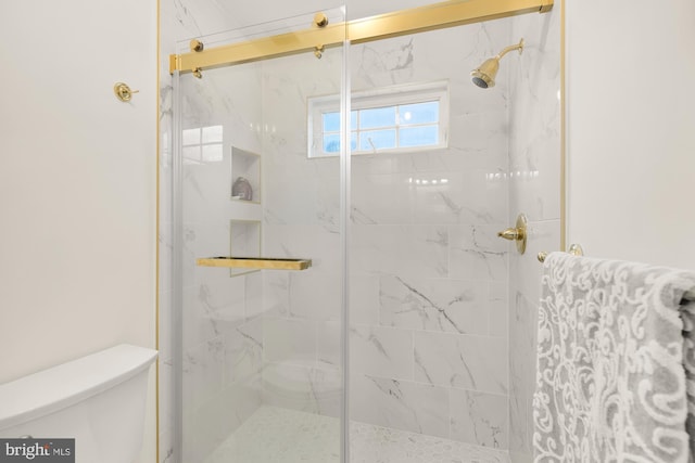 full bath with toilet and a marble finish shower