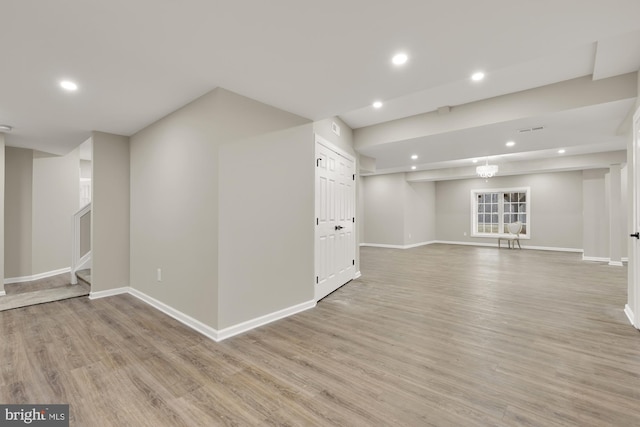 basement featuring recessed lighting, baseboards, and light wood finished floors