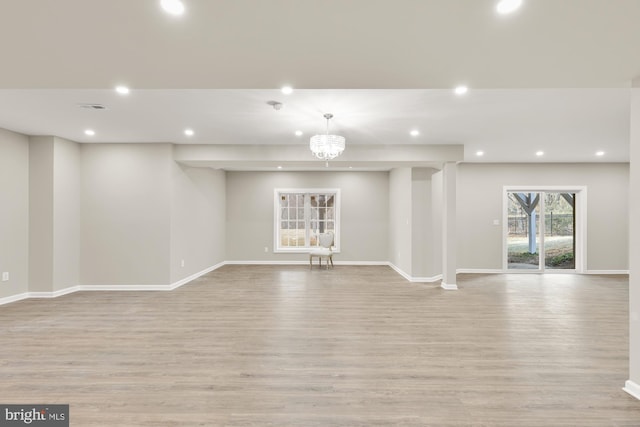 unfurnished living room featuring baseboards, light wood-style floors, and recessed lighting