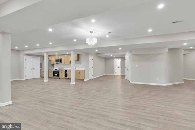 unfurnished living room with baseboards, light wood-style floors, visible vents, and recessed lighting