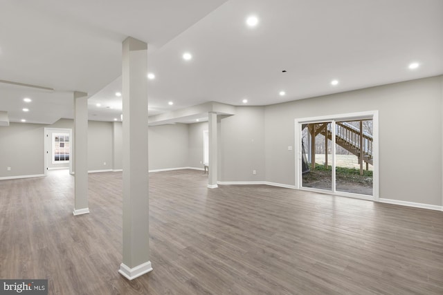 basement featuring recessed lighting, baseboards, and wood finished floors