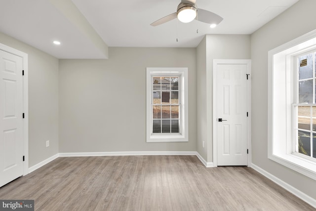 empty room with light wood-style floors, baseboards, a ceiling fan, and recessed lighting