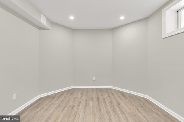 basement with baseboards, wood finished floors, and recessed lighting