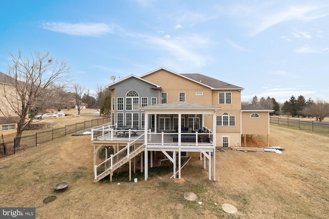 back of property featuring stairs, a fenced backyard, a wooden deck, and a sunroom