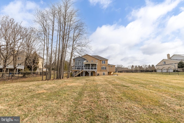 view of yard with fence, stairway, and a wooden deck