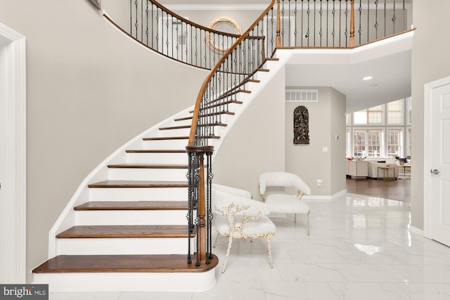 stairs featuring visible vents, baseboards, a towering ceiling, marble finish floor, and recessed lighting