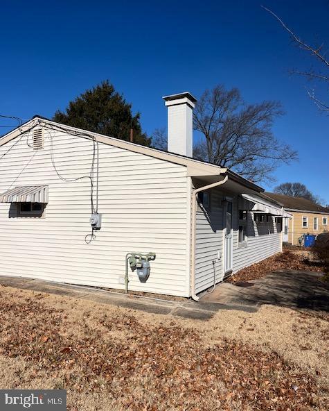 view of side of home featuring a chimney