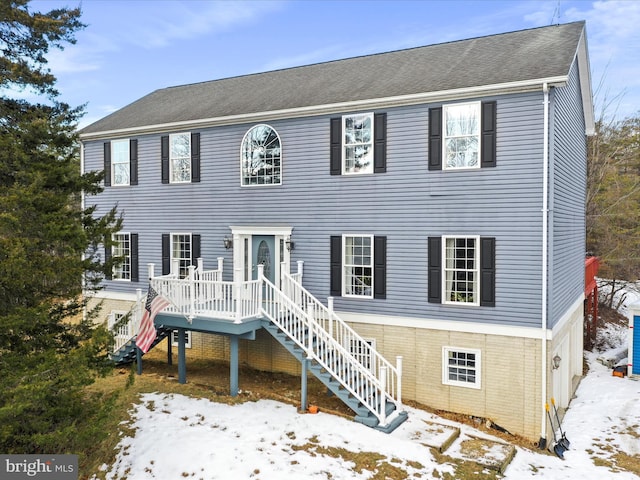 colonial inspired home featuring a wooden deck