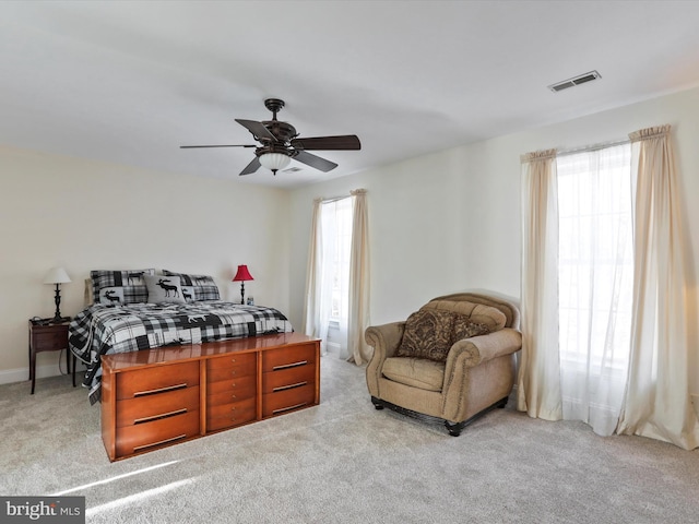 bedroom with light colored carpet and ceiling fan