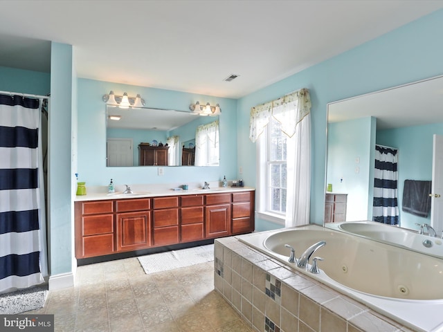 bathroom with vanity and tiled bath