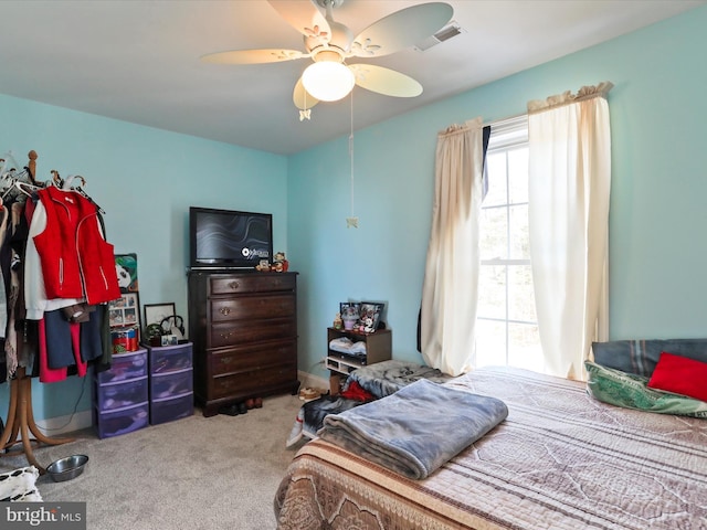 bedroom with ceiling fan and carpet floors