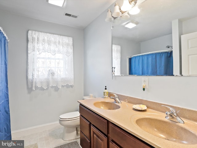 bathroom featuring vanity, walk in shower, and toilet