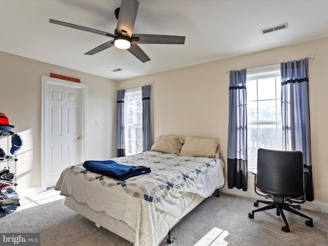 bedroom with light colored carpet and ceiling fan