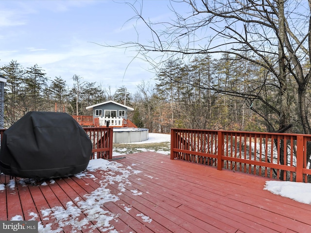 snow covered deck featuring a grill