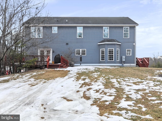 snow covered property featuring a wooden deck