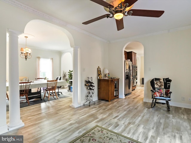 living area featuring ornamental molding, decorative columns, and light hardwood / wood-style floors